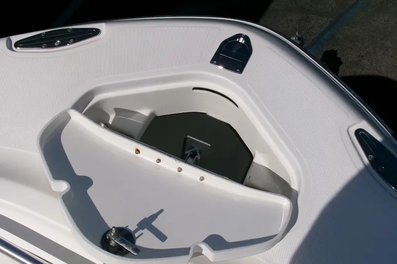 Slide: The Image of 2009 Hydra-Sports 2500 CC boat anchor storage compartment, featuring sleek white design. - 6