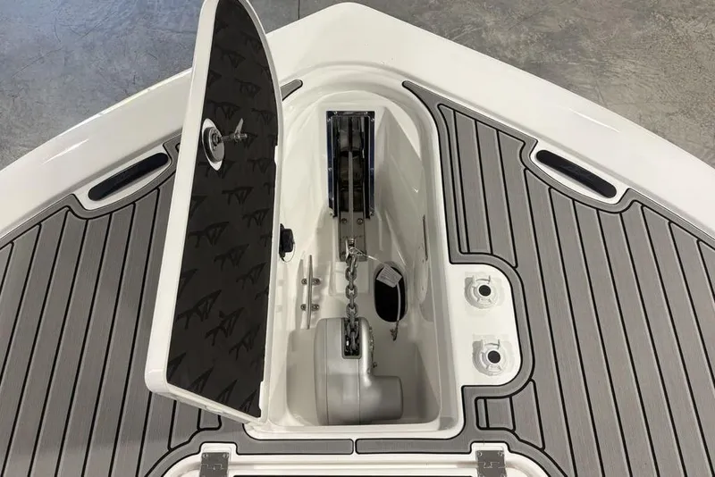 Slide: The Image of 2026 Tidewater 3100 Carolina Bay boat anchor compartment with open hatch and sleek deck design. - 10
