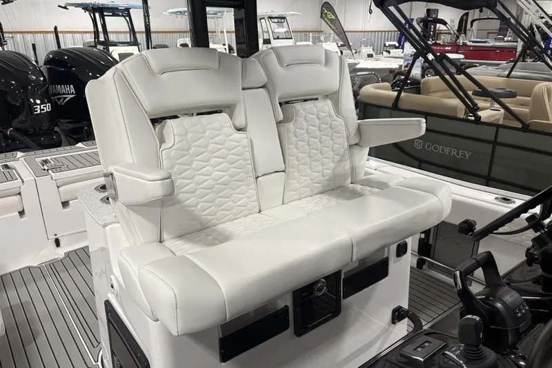 Slide: The Image of 2026 Tidewater 3100 Carolina Bay boat interior with luxurious white seating and modern controls. - 24