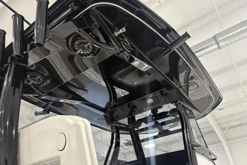 Slide: The Image of 2026 Tidewater 3100 Carolina Bay boat's sleek black T-top with integrated speakers. - 26