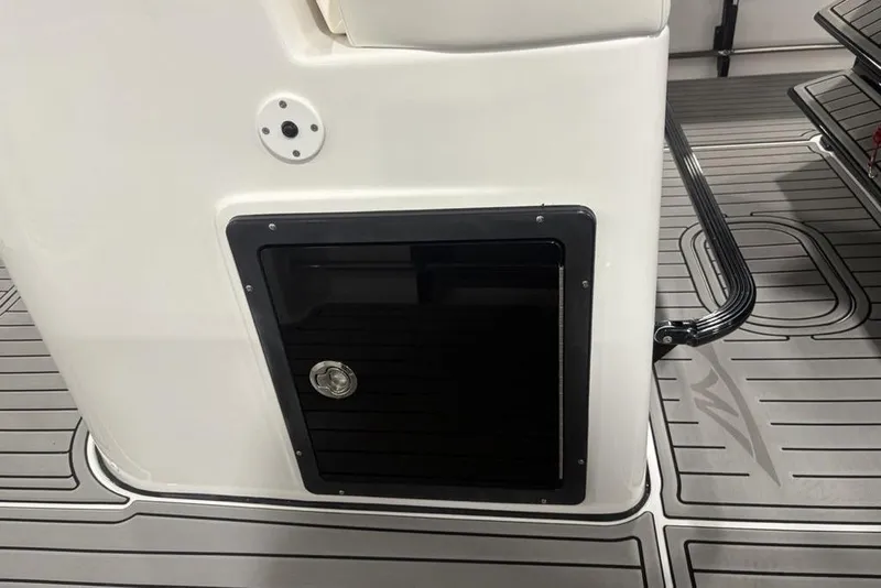 Slide: The Image of 2026 Tidewater 3100 Carolina Bay boat interior with storage compartment and sleek flooring. - 28