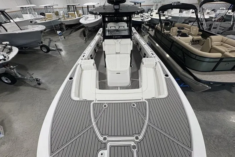 Slide: The Image of 2026 Tidewater 3100 Carolina Bay boat in showroom, featuring sleek design and spacious seating. - 35