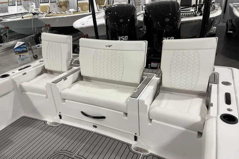 Slide: The Image of 2026 Tidewater 3100 Carolina Bay boat with white cushioned seating and dual Yamaha 350 engines. - 36