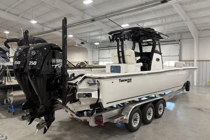 Slide: The Image of 2026 Tidewater 3100 Carolina Bay boat with dual Yamaha 350 engines in a showroom. - 5