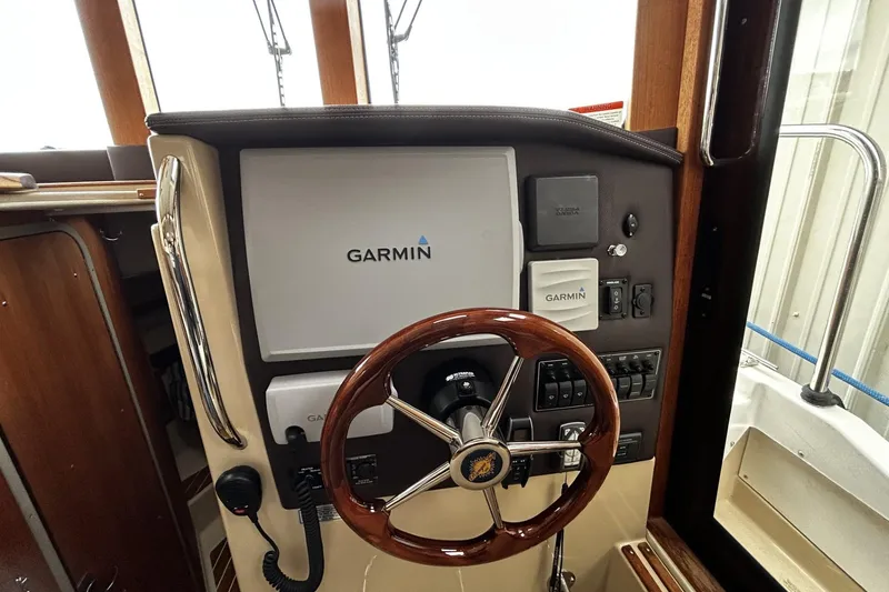 Slide: The Image of 2015 Ranger Tugs R-31 CB helm with Garmin navigation system and wooden steering wheel. - 18