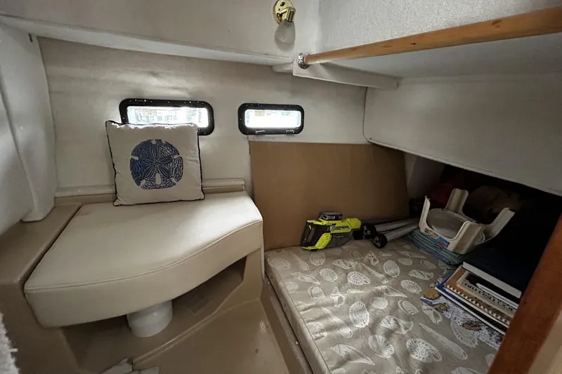 Slide: The Image of 2015 Ranger Tugs R-31 CB cabin interior with seating, cushion, and tools. - 20