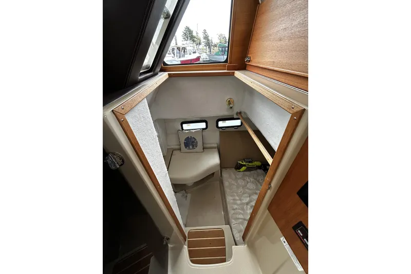 Slide: The Image of 2015 Ranger Tugs R-31 CB cabin interior with wooden accents and compact design. - 21