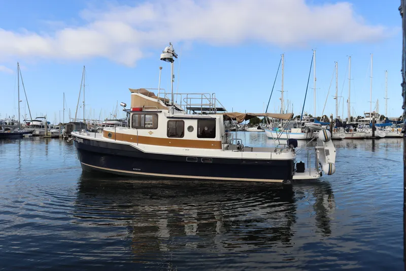Slide: The Image of 2015 Ranger Tugs R-31 CB boat docked in a marina with clear blue skies. - 4