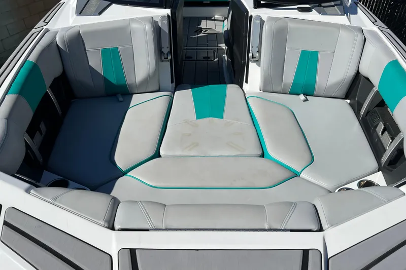 Slide: The Image of 2020 Malibu Wakesetter 23 MXZ boat interior with gray and teal seating. - 13