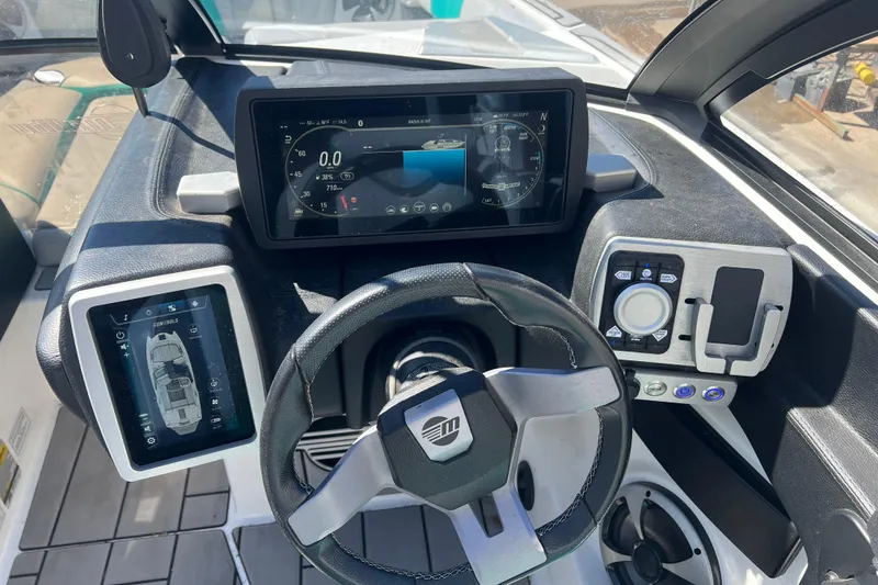 Slide: The Image of 2020 Malibu Wakesetter 23 MXZ dashboard with advanced digital controls and steering wheel. - 18