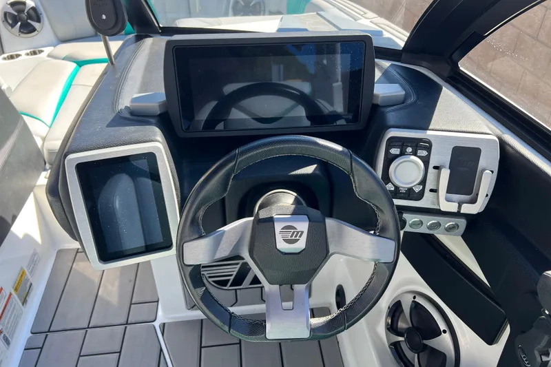 Slide: The Image of 2020 Malibu Wakesetter 23 MXZ dashboard with touchscreen controls and steering wheel. - 24