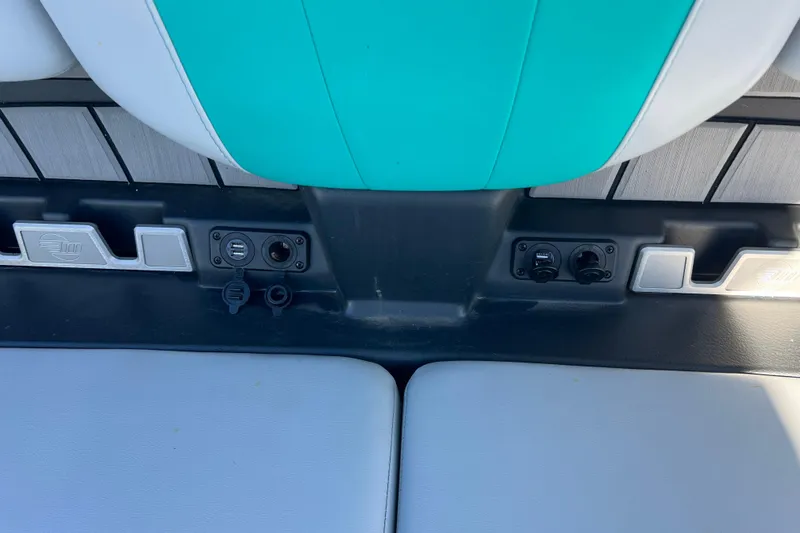Slide: The Image of 2020 Malibu Wakesetter 23 MXZ boat interior with teal and white seating, USB ports, and controls. - 27