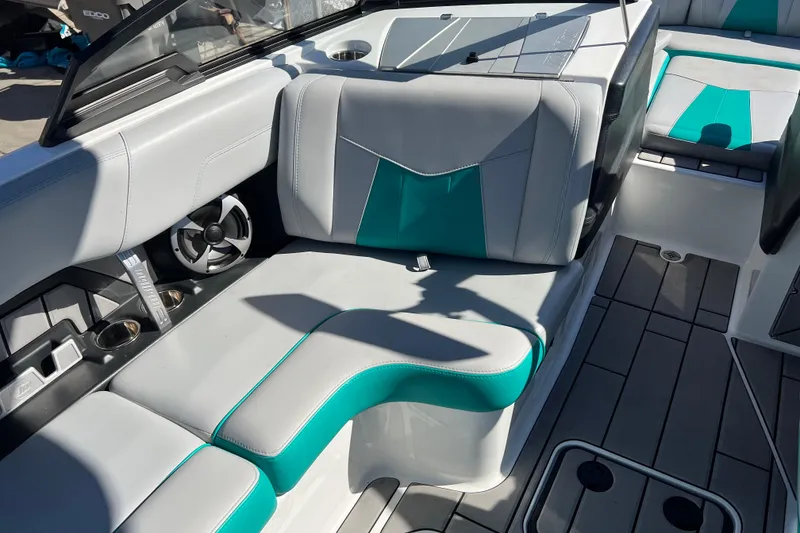 Slide: The Image of 2020 Malibu Wakesetter 23 MXZ interior with teal and gray seating, cup holders, and speaker. - 29