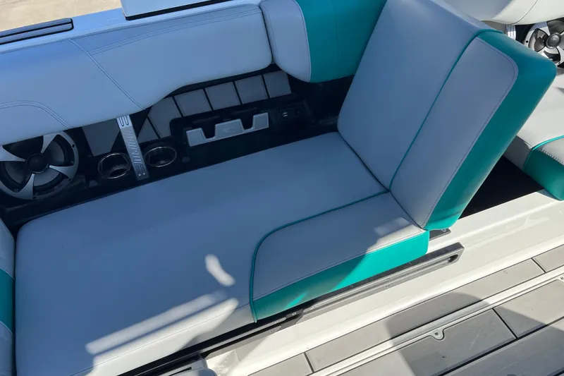 Slide: The Image of 2020 Malibu Wakesetter 23 MXZ interior seating with teal accents and cup holders. - 30