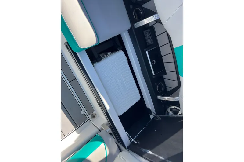 Slide: The Image of 2020 Malibu Wakesetter 23 MXZ interior with storage compartment and cooler. - 31