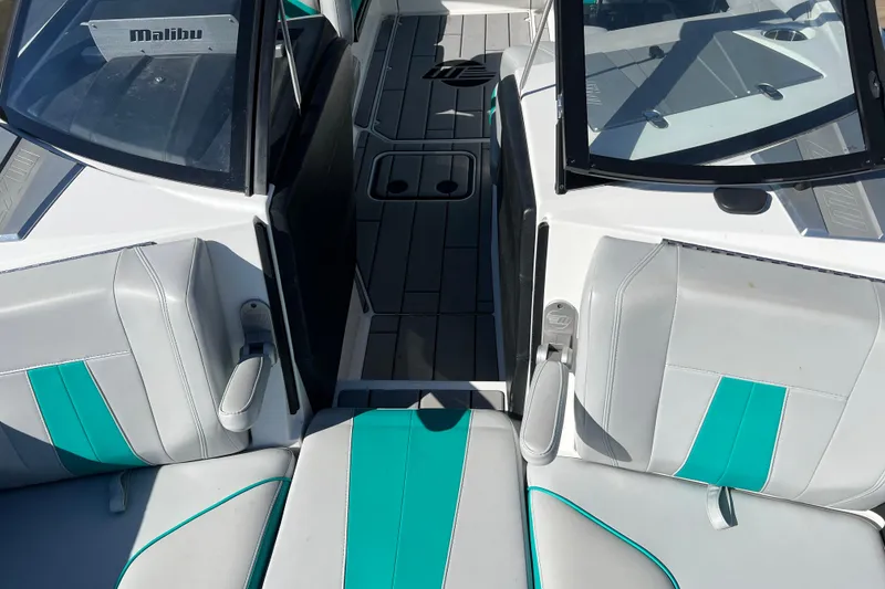 Slide: The Image of 2020 Malibu Wakesetter 23 MXZ interior with teal and gray seating. - 36