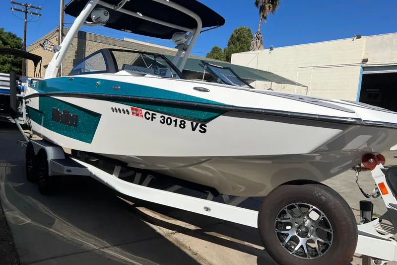 Slide: The Image of 2020 Malibu Wakesetter 23 MXZ boat on trailer, parked outdoors. - 38