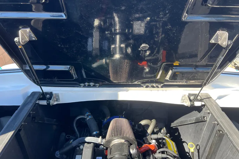 Slide: The Image of 2020 Malibu Wakesetter 23 MXZ engine compartment with open hatch, showcasing internal components. - 7