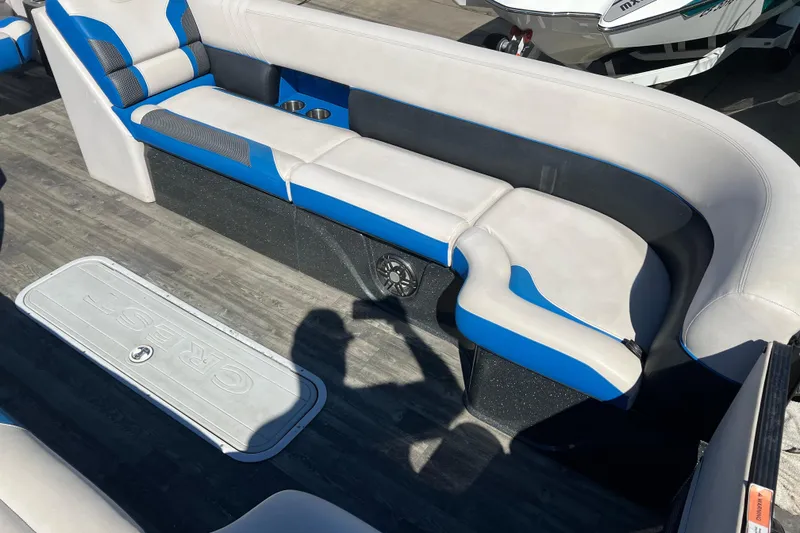 Slide: The Image of 2020 Crest Caribbean RS 250 SLRC boat interior with blue and white seating and cup holders. - 10
