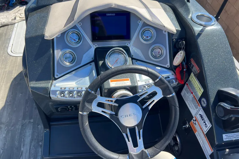 Slide: The Image of 2020 Crest Caribbean RS 250 SLRC boat dashboard with steering wheel and gauges. - 11
