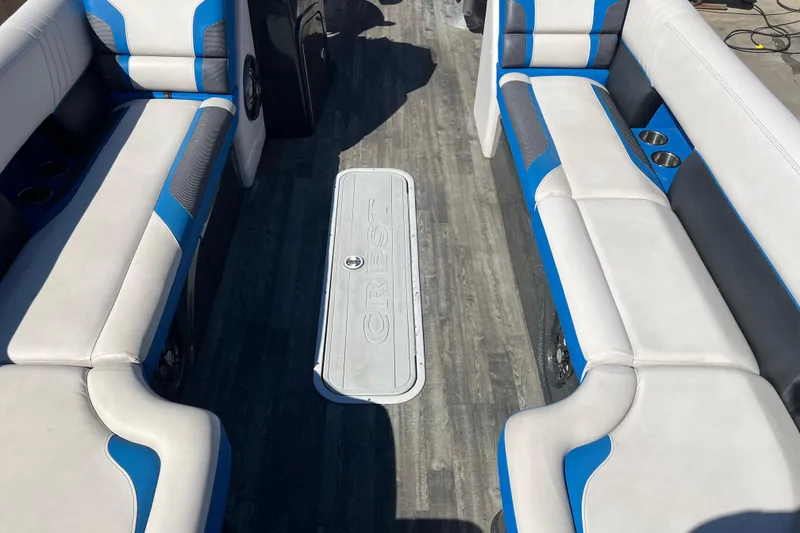 Slide: The Image of 2020 Crest Caribbean RS 250 SLRC boat interior with blue and white seating. - 13