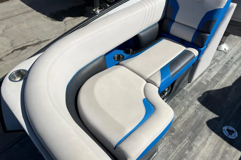 Slide: The Image of 2020 Crest Caribbean RS 250 SLRC boat seating with blue and white upholstery, cup holders. - 14
