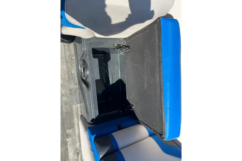 Slide: The Image of 2020 Crest Caribbean RS 250 SLRC boat seat storage compartment open, blue and gray upholstery. - 25