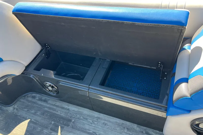 Slide: The Image of 2020 Crest Caribbean RS 250 SLRC boat seat storage compartment open, revealing interior space. - 27