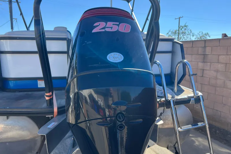 Slide: The Image of 2020 Crest Caribbean RS 250 SLRC boat engine with ladder, parked outdoors. - 31