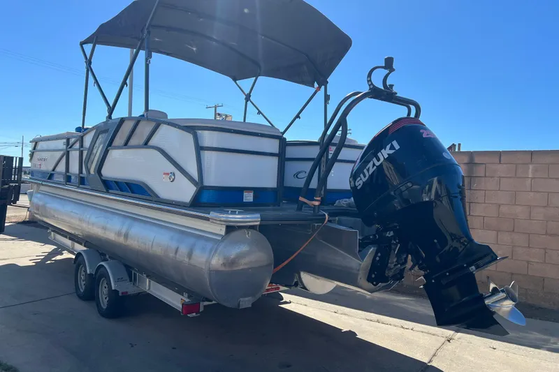 Slide: The Image of 2020 Crest Caribbean RS 250 SLRC pontoon boat with Suzuki outboard motor on trailer. - 4