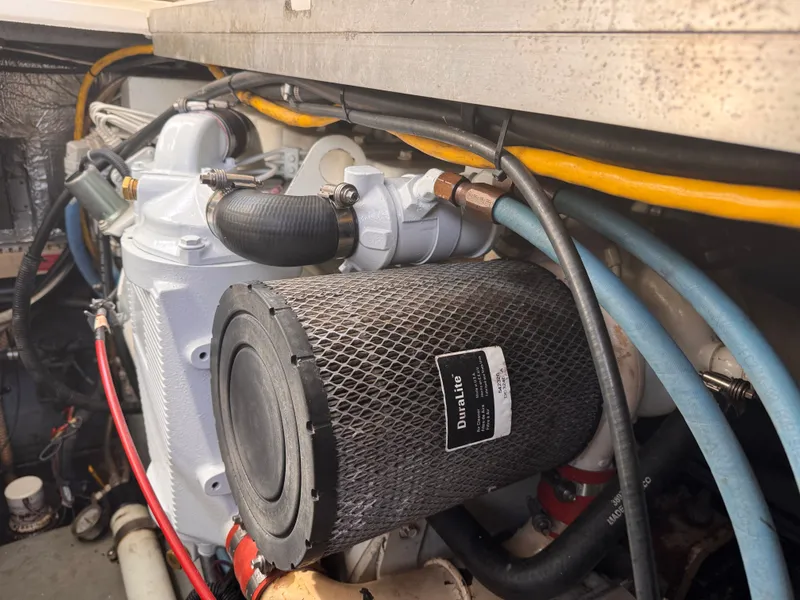 Slide: The Image of Engine compartment of a 1995 Sea Ray 400 Express Cruiser with visible hoses and filter. - 7