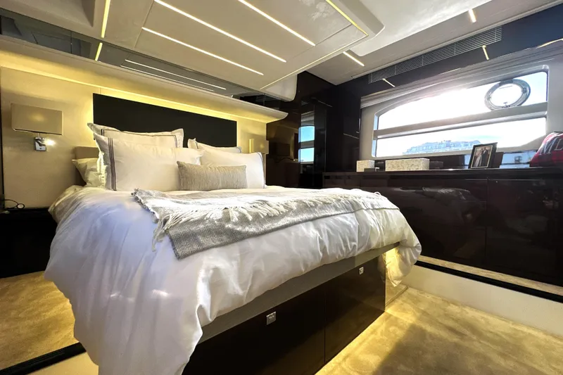Slide: The Image of Luxurious bedroom interior of 2023 Prestige 590 yacht with elegant bedding and modern design. - 2