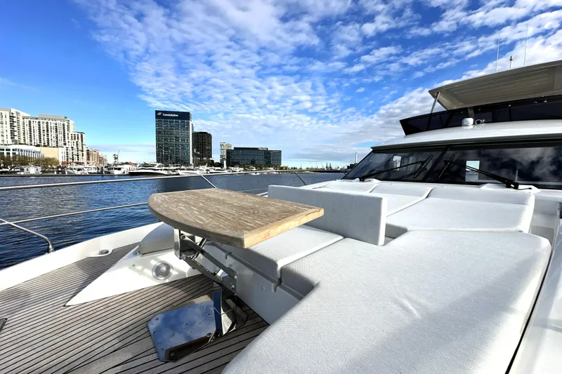 Slide: The Image of Luxurious 2023 Prestige 590 yacht with elegant deck, city skyline in background. - 20