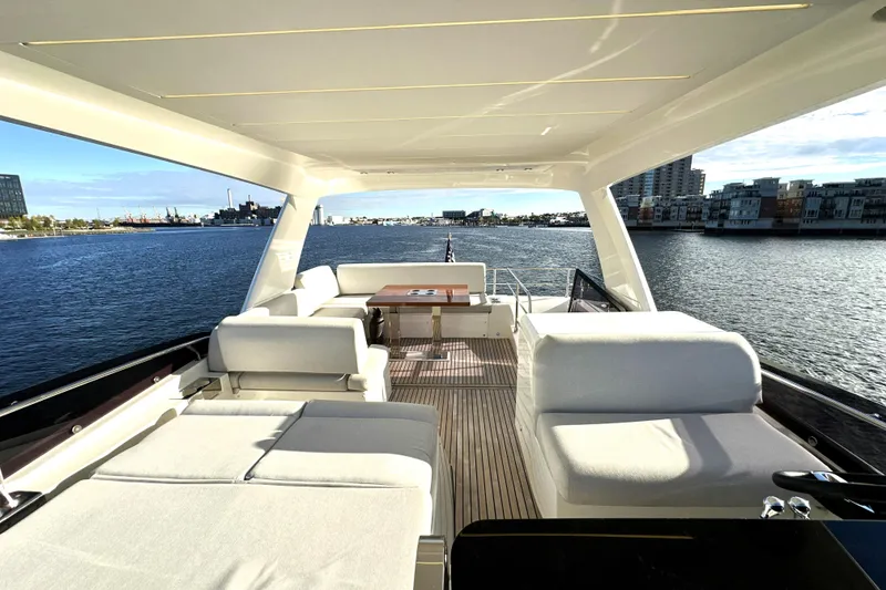 Slide: The Image of Luxurious 2023 Prestige 590 yacht interior with elegant seating and scenic waterfront view. - 22