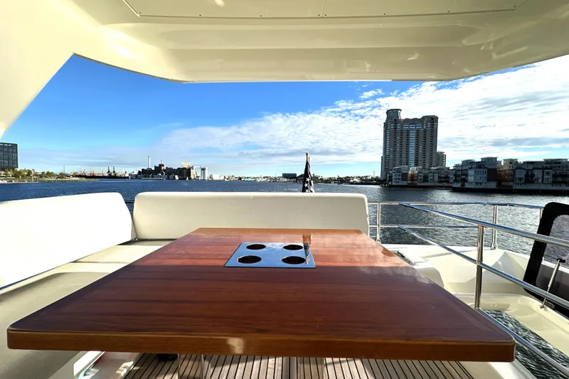Slide: The Image of Luxurious 2023 Prestige 590 yacht deck with cityscape and waterfront views. - 25