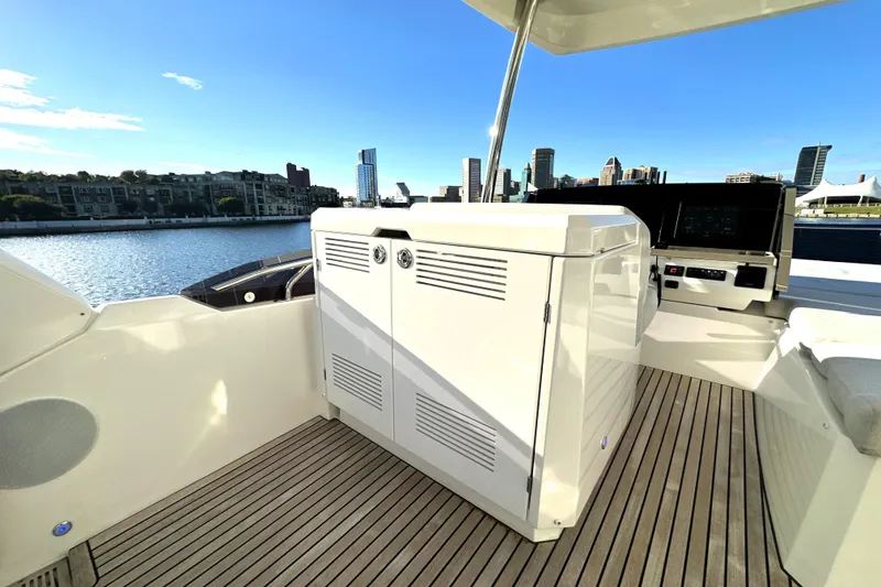 Slide: The Image of Luxurious 2023 Prestige 590 yacht deck with city skyline view. - 28