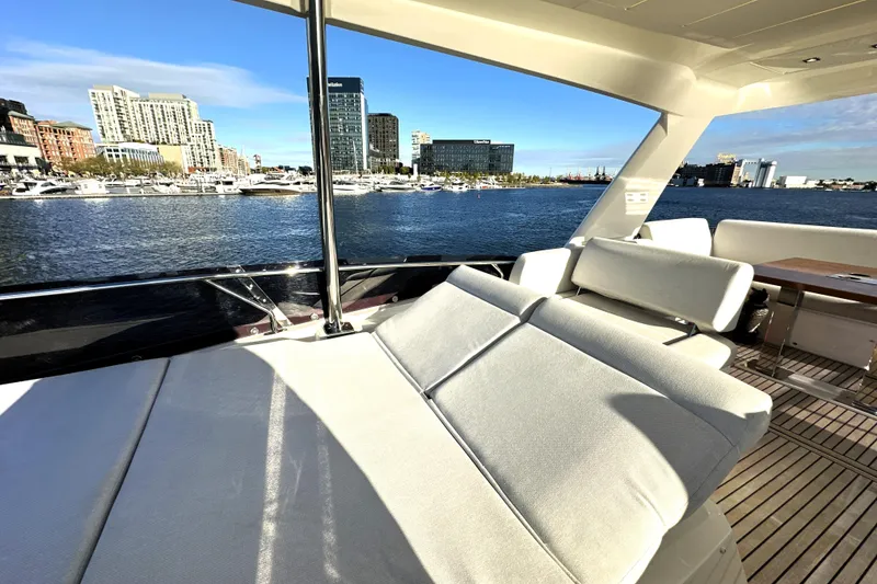 Slide: The Image of Luxurious 2023 Prestige 590 yacht with spacious deck, city skyline view, and waterfront marina. - 31