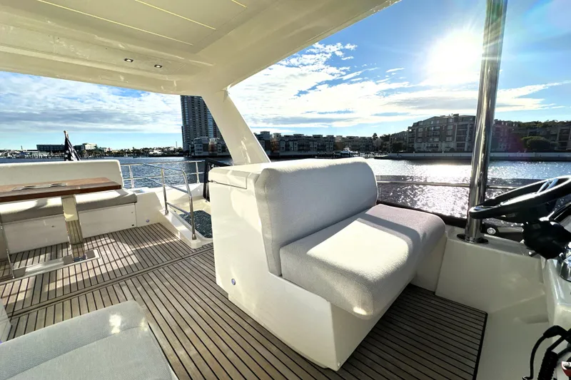 Slide: The Image of Luxurious 2023 Prestige 590 yacht interior with waterfront view and elegant seating. - 32