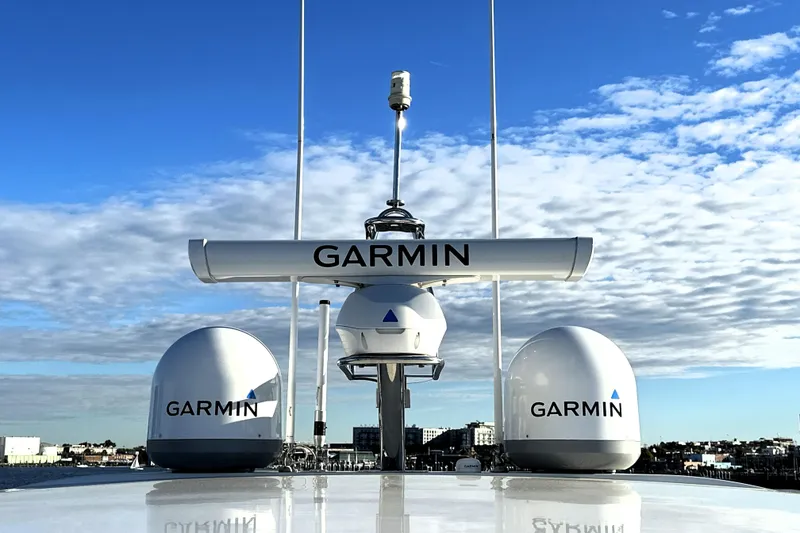 Slide: The Image of Garmin radar equipment on 2023 Prestige 590 yacht under a clear blue sky. - 36