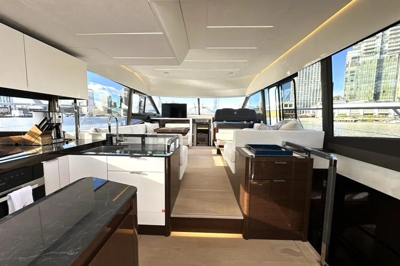 Slide: The Image of Luxurious interior of 2023 Prestige 590 yacht with modern kitchen and panoramic windows. - 37