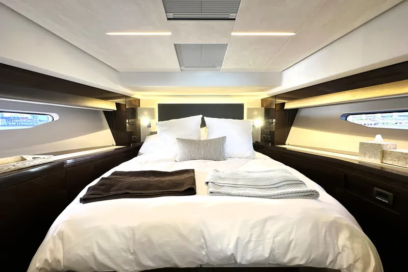 Slide: The Image of Luxurious bedroom interior of 2023 Prestige 590 yacht with elegant bedding and modern design. - 4
