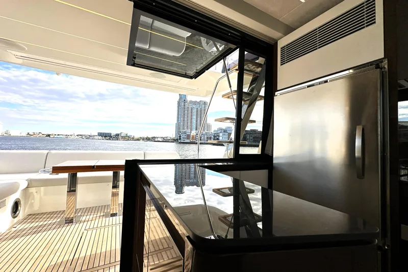 Slide: The Image of Luxurious 2023 Prestige 590 yacht interior with modern kitchen and scenic waterfront view. - 41
