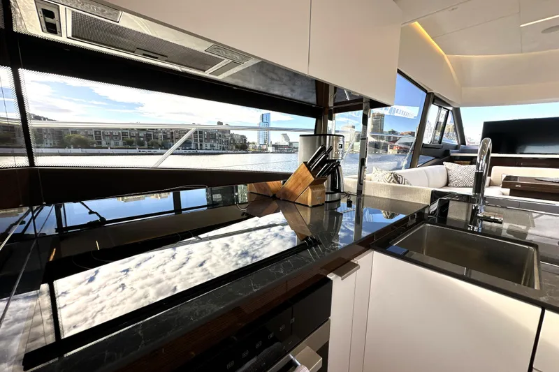 Slide: The Image of Luxurious interior of 2023 Prestige 590 yacht with modern kitchen and scenic views. - 43