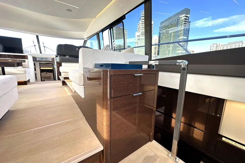 Slide: The Image of Luxurious interior of 2023 Prestige 590 yacht with modern furnishings and cityscape view. - 45