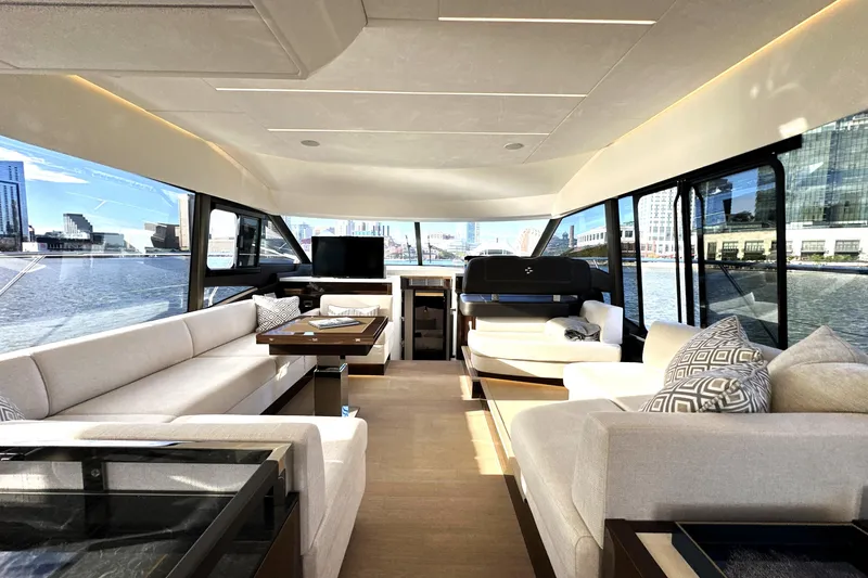 Slide: The Image of Luxurious interior of 2023 Prestige 590 yacht with panoramic windows and elegant seating. - 46