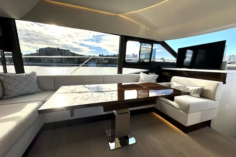 Slide: The Image of Luxurious interior of 2023 Prestige 590 yacht with elegant seating and waterfront view. - 48