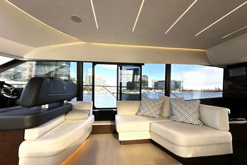 Slide: The Image of Luxurious interior of 2023 Prestige 590 yacht with modern seating and waterfront view. - 49