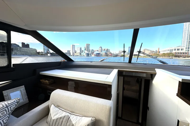 Slide: The Image of Interior view of 2023 Prestige 590 yacht with cityscape through large windows. - 50