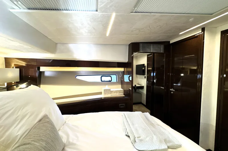 Slide: The Image of Luxurious interior of 2023 Prestige 590 yacht, featuring elegant bedroom design and modern amenities. - 60