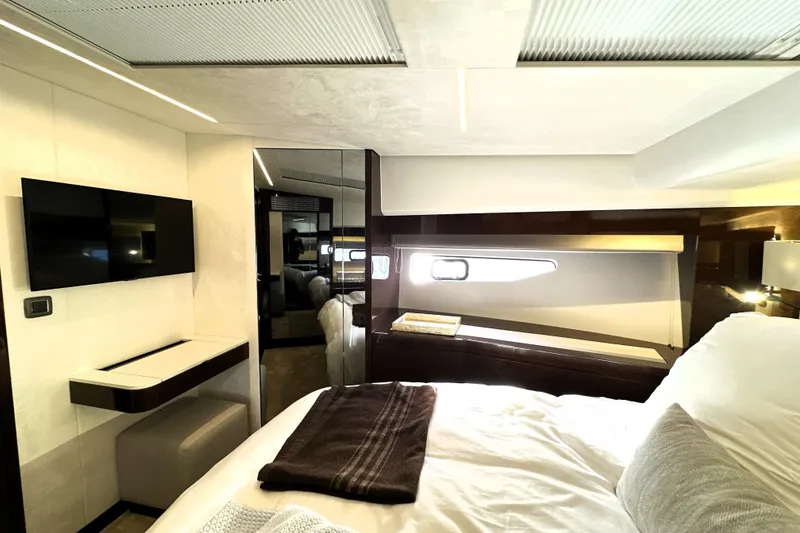 Slide: The Image of Luxurious interior of 2023 Prestige 590 yacht bedroom with modern decor and natural lighting. - 61
